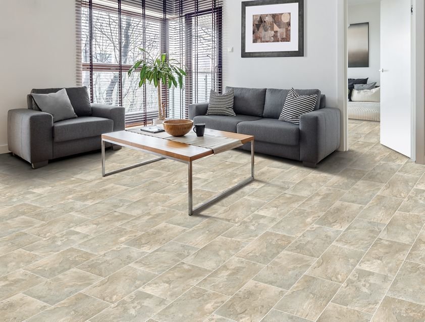 Light brown wood-look flooring in a family room with fireplace.